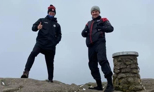 To go with story by Ellie Milne. Luke Mackie is climbing Bennachie 17 time to raise money for Cancer Research UK. Picture shows; Luke Mackie and a friend at Bennachie. Bennachie. Supplied by Adrienne Mackie Date; 05/05/2021