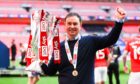 Derek Adams with the silverware at Wembley after taking Morecambe into League One via the play-off final against Newport County. Picture by Kieran McManus/BPI/Shutterstock
