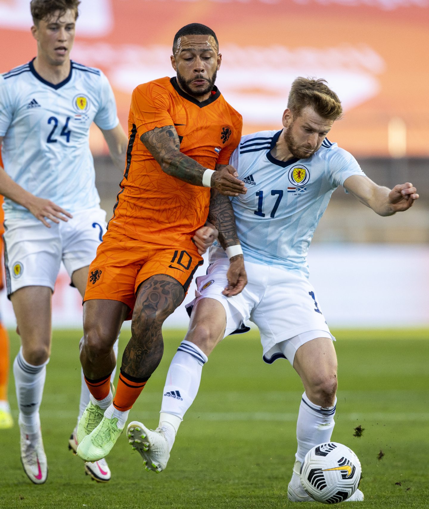 Scotland midfielder Stuart Armstrong battles Memphis Depay of Netherlands for possession. 