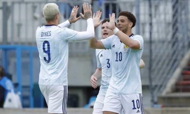 Scotland's Che Adams celebrates making it 1-0 with Lydnon Dykes (left) against Luxembourg.