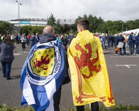 Scotland fans draped in flags.