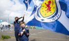 Youngsters proudly wave the flag for the Scotland national team.