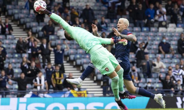 Czech Republic goalkeeper Tomas Vaclik claws the ball away under pressure from Lyndon Dykes. Picture by SNS.