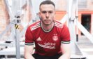Andy Considine models Aberdeen's new home kit.