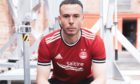 Andy Considine models Aberdeen's new home kit.