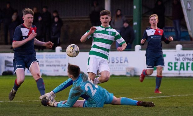 Goalkeeper Tim Findlay, on the ground, in action for Turriff United