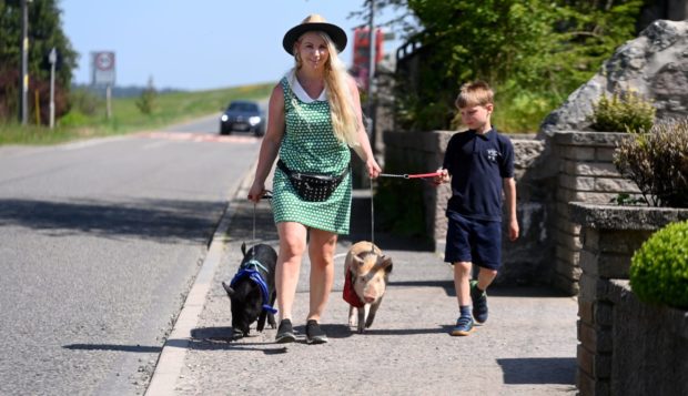 Michelle Barclay-Dunbar from Oyne, her son Brandyn and pet piglets. Picture by Chris Sumner