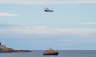 This is the scene of the coastguard helicopter from Inverness along with lifeboat from Buckie and police searching at Cullen Bay. PIC: Brian Smith