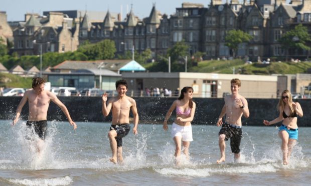 Kris Miller, Courier, 03/06/11. Picture today at West sands, St Andrews shows Andreas Anderson, Rosie Collinge, Martin Kenmore, Anastasiya Shkurko and Fritz Lodge, all students at St Andrews who enjoyed a day at the beach thanks to the unusually warm weather.