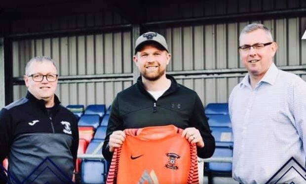 Goalkeeper Robert Donaldson is flanked by new Strathspey Thistle manager Charlie Brown, left, and committee member Ian Anderson.