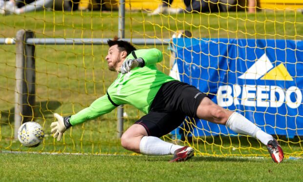 Forres Mechanics keeper Stuart Knight goes in the right direction but could not save a second penalty of the game, with Manny Duku netting.
