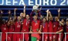 Cristiano Ronaldo of Portugal (c) lifts the Henri Delaunay trophy after his side defeated France 1-0 in the final of Euro 2016.