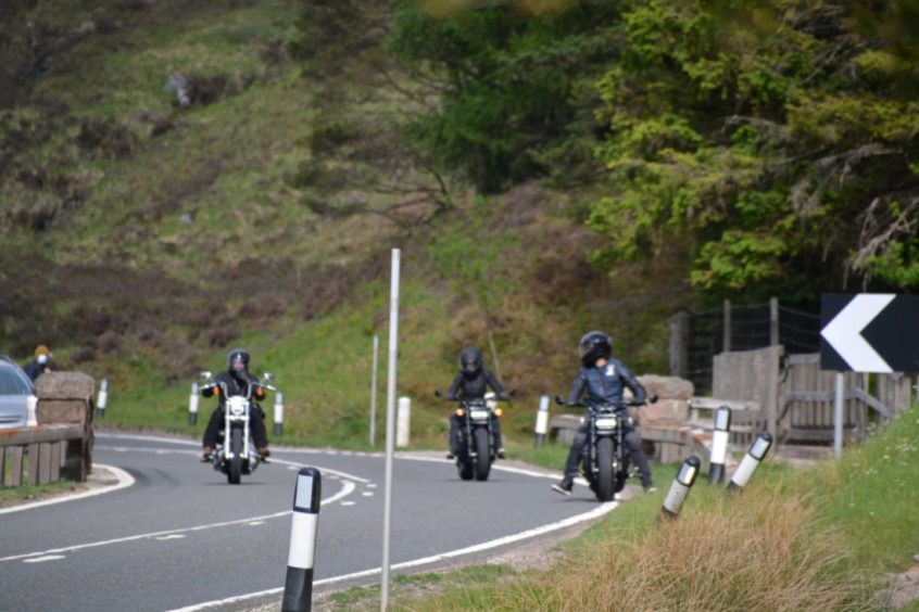 These exclusive photos of stunt actors racing on motorbikes through the village of Glencoe, western Scotland.