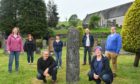 Dufftown and Mortlach Development Trust directors near a Pictish stone hope projects in the town can aid regeneration mission.