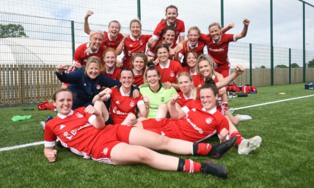 The Aberdeen FC Women squad celebrate after winning the title at Dundee United