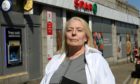 CR0028721
Fiona Campbell has started a petition against the possible closure of Seaton Post Office at Spar, St Machar Drive. She says it will lead to the isolation of elderly and vulnerable residents. 

Picture by Kenny Elrick     03/06/2021