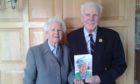 Colonel and Mrs le Gassick with their 60th wedding anniversary card from the Queen.
