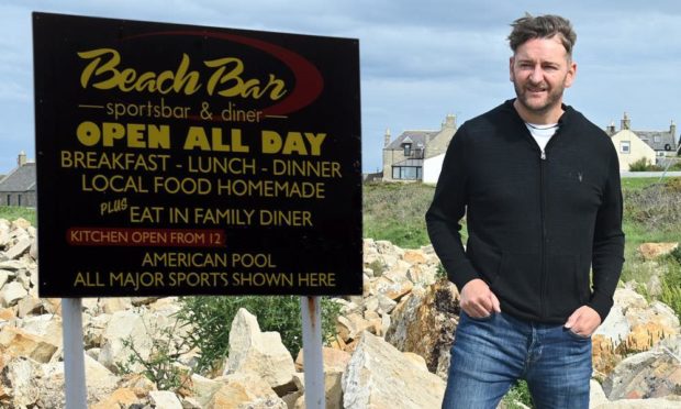 Owner of the Lossiemouth Beach Bar Graham Fleming alongside how the bar's outside sign appeared before the fire.