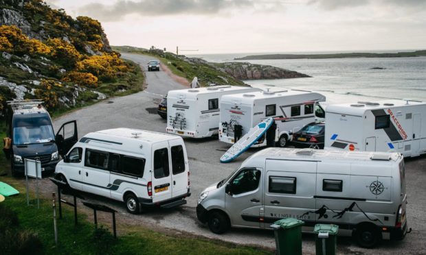 Campervans parked at at Ceannabeinne Beach, near Durness, on the North Coast 500.