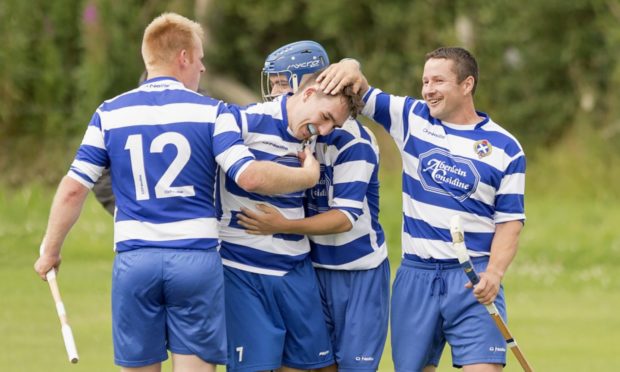 Newtonmore's Michael Russell (centre) celebrates  with team mates.