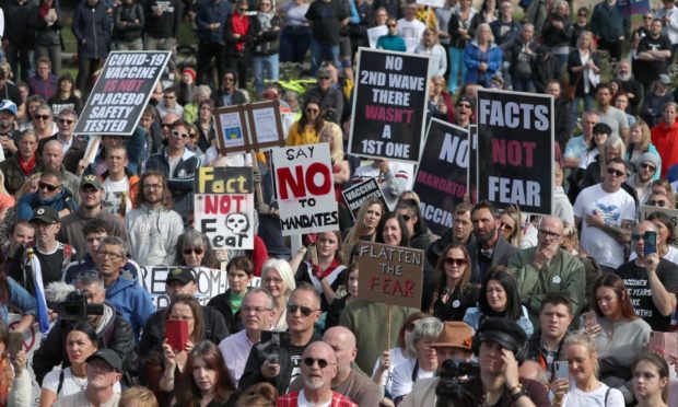 Protesters gathered outside the Scottish Parliament in September to protest lockdown measures and the wearing of face coverings, with some placards referencing Covid conspiracy theories.