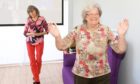 Two elderly women dancing at the Forget Me Not Club