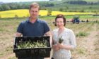 Neil and Jillian McEwan posing with a box of Lunan Bay Farm asparagus