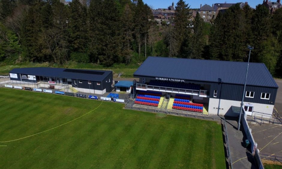 An aerial view of The Haughs in Turriff, the grass is well cut with the stand in the background. 