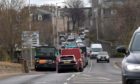Queues are common place in Berryden Road at the junction with Hutcheon Street - but the council has been allowed to acquire all the land needed to build a new dual carriageway.