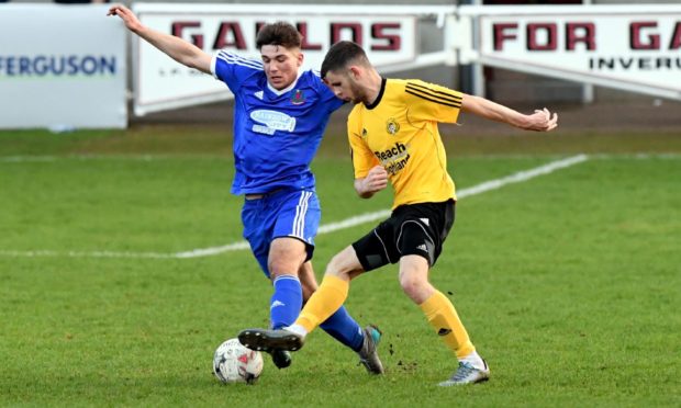 Dylan Mackenzie, right, in action for Nairn County.