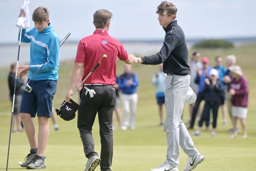 Calum Scott wins on the 19th and is congratulated by Hlynur Bergsson after winning in the second round.