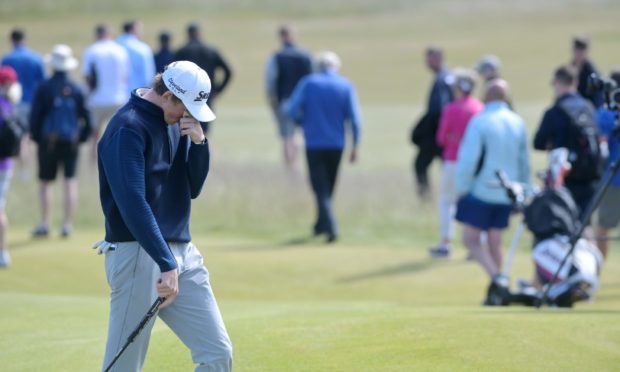A disappointed Calum Scott makes his way off the 16th green having had a poor putt. Pictures by Sandy McCook