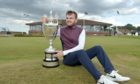 Laird Shepherd gets his hands on the Amateur Championship trophy after his stunning comeback triumph.
