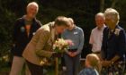 The Princess Royal receives a bouquet from two-year-old Cornelius Dean.