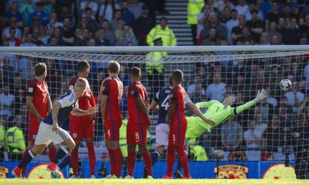 Scotland's Leigh Griffiths scores a free kick in the World Cup qualifier against England