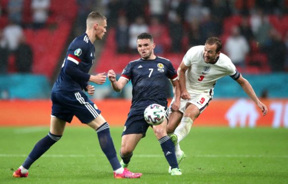 England's Harry Kane (right) and Scotland's John McGinn (centre).