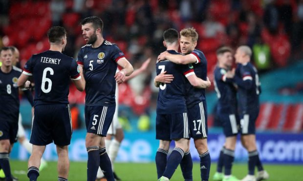 Scotland players embrace at the close of the game.