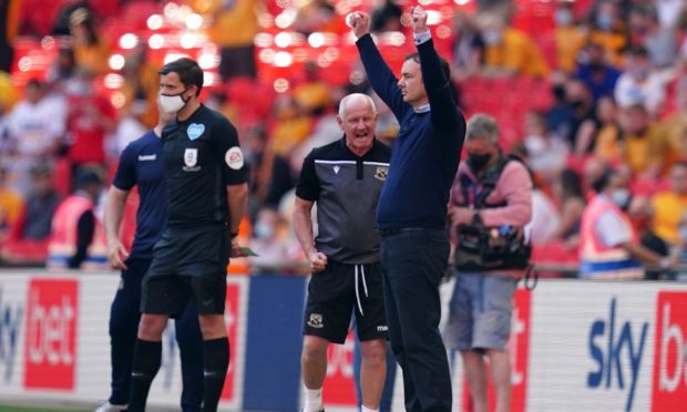 Derek Adams celebrates on the touchline towards the end of the Sky Bet League Two play-off final at Wembley where his Morecambe side defeated Newport 1-0.
Picture by John Walton/PA Wire