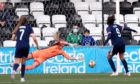 Scotland's Caroline Weir, right, scores the winning goal from the penalty spot