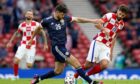 Scotland's Scott McKenna (left) and Croatia's Bruno Petkovic battle for the ball during the UEFA Euro 2020 Group D match at Hampden Park, Glasgow. Picture date: Tuesday June 22, 2021. PA Photo. See PA story SOCCER Scotland. Photo credit should read: Andrew Milligan/PA Wire.
 
RESTRICTIONS: Use subject to restrictions. Editorial use only, no commercial use without prior consent from rights holder.