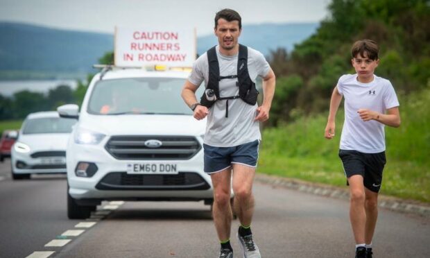 Steven Mackay (left) and his son Dylan during his 104-mile ultramarathon challenge.