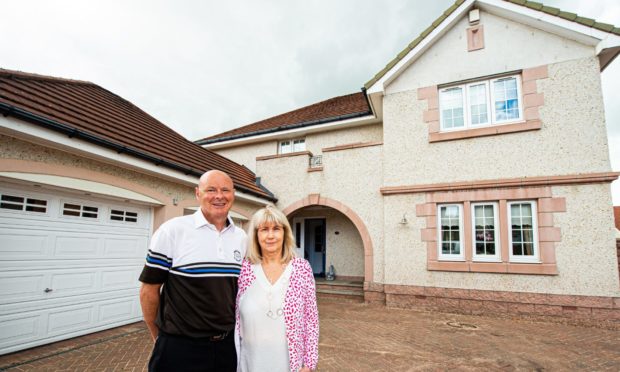 Scott and Wendy Robertson outside their stunning home in Grandholm Grove.