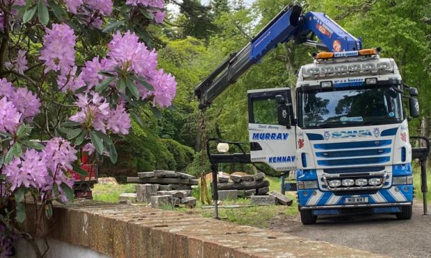 A lorry loads the AWOL granite from Union Terrace Gardens onto a Graeme Cheyne flatbed van.