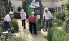 Picture shows: Braemar Lodge resident Joan Hills, far right, was among those who supported the Braemar-to-Braemar walking challenge. Joining her in the care home garden are, from left, Chef Frankie Collingwood, Clinical Lead Jackie Cash and Home Manager Alison Bremner.