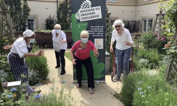 Picture shows: Braemar Lodge resident Joan Hills, far right, was among those who supported the Braemar-to-Braemar walking challenge. Joining her in the care home garden are, from left, Chef Frankie Collingwood, Clinical Lead Jackie Cash and Home Manager Alison Bremner.