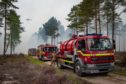 12.09.2020 - Culbin Forest in Moray was cordened off due to a wildfire. A helicopter loaded with a water bowser is brought in to help stop the spread of fire throughout the forrest amplified due to high winds.
Pictures by JASON HEDGES