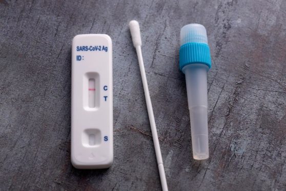 Covid-19 lateral flow test kit on grey surface;