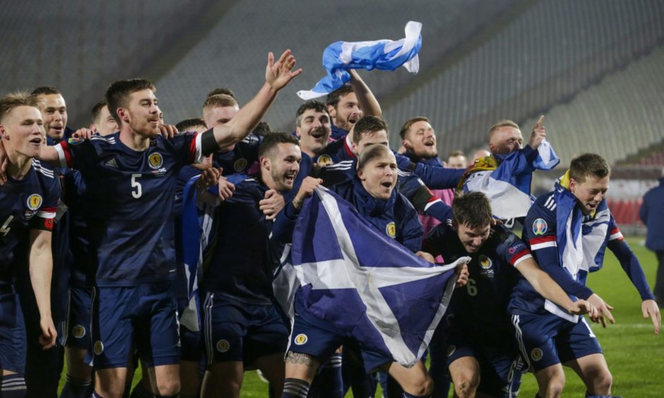Scotland's players celebrate after winning the penalty shootout of the UEFA EURO 2020 qualification playoff match between Serbia.