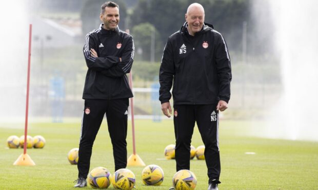 Aberdeen manager Stephen Glass and coach Neil Simpson during training earlier today.