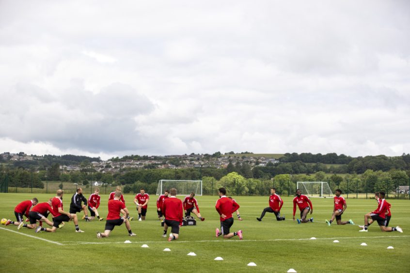 The Aberdeen squad stretch.